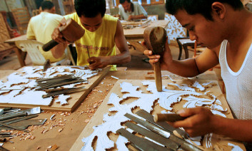 Men carve a pattern from a paper template. Jepara, Central Java, Indonesia. Photo by Murdani Usman/CIFOR via Flickr 